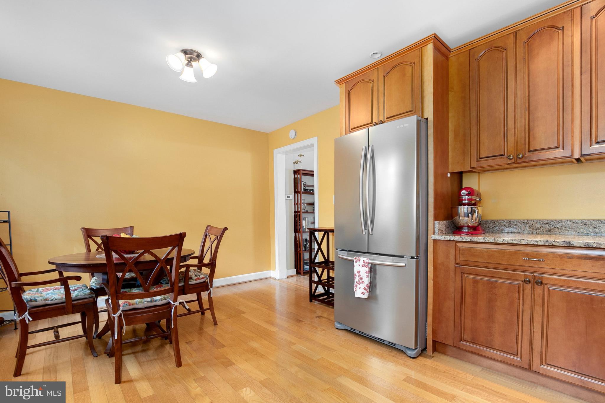2700 13th Road South, Unit 379 Arlington, VA 22204 - Photo 12 of 26 a kitchen with stainless steel appliances granite countertop a refrigerator and wooden cabinets
