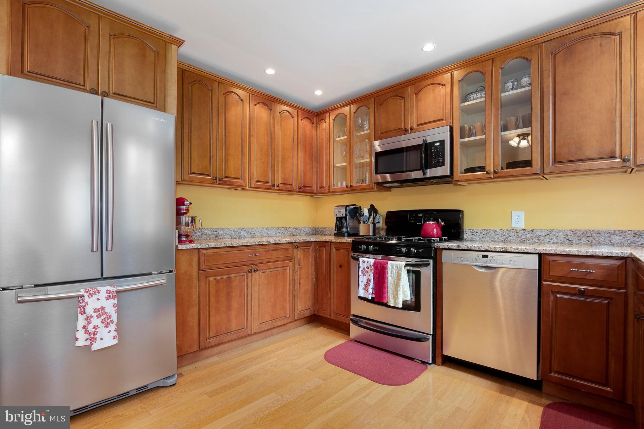2700 13th Road South, Unit 379 Arlington, VA 22204 - Photo 9 of 26 a kitchen with stainless steel appliances granite countertop a refrigerator and a stove top oven