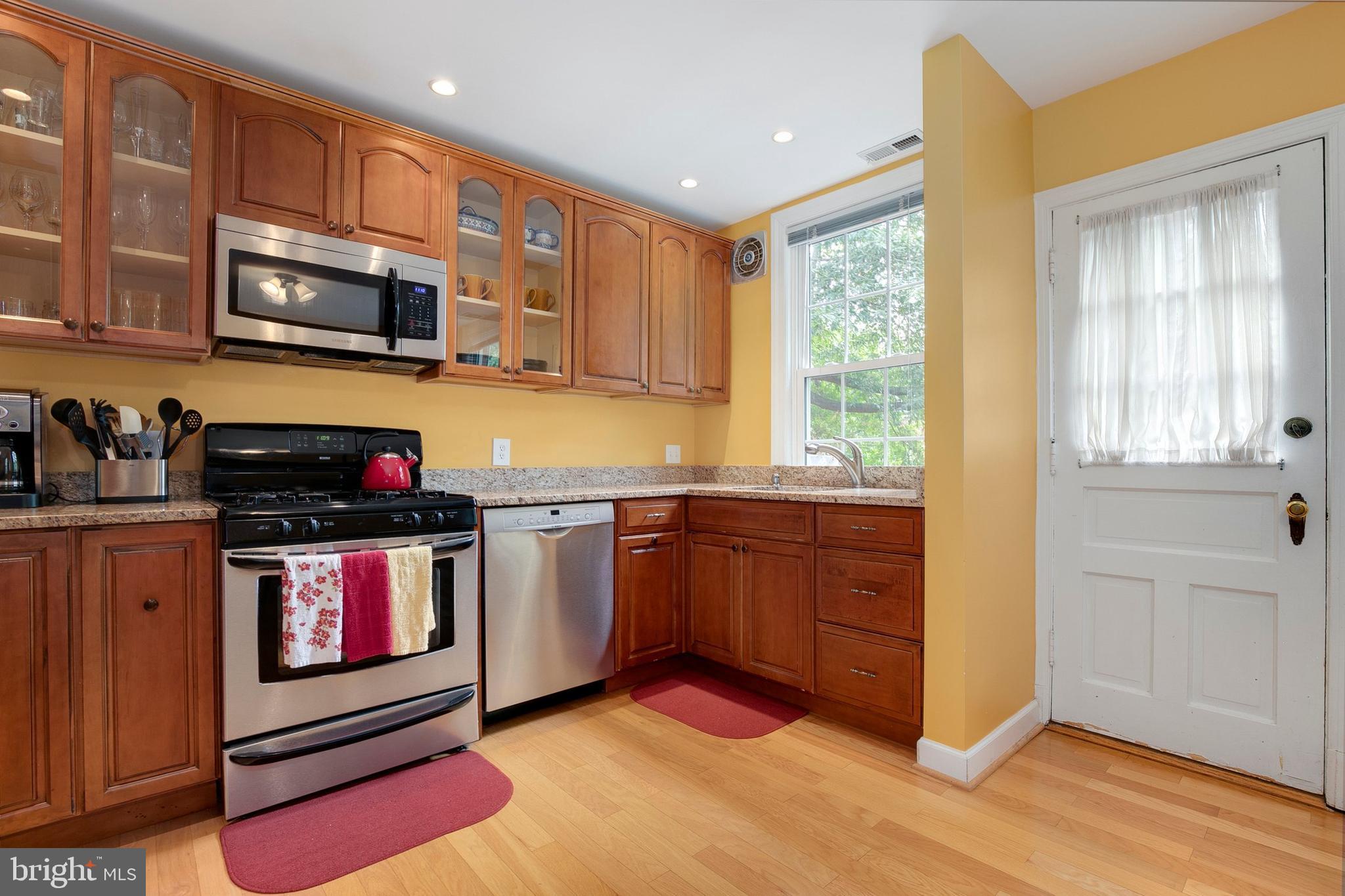 2700 13th Road South, Unit 379 Arlington, VA 22204 - Photo 10 of 26 a kitchen with stainless steel appliances granite countertop a stove a sink and a microwave