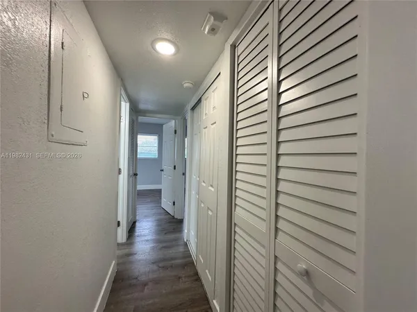 a view of a hallway with wooden floor