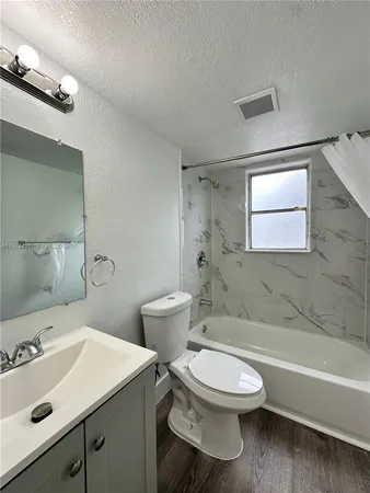 a bathroom with a sink a toilet and bathtub