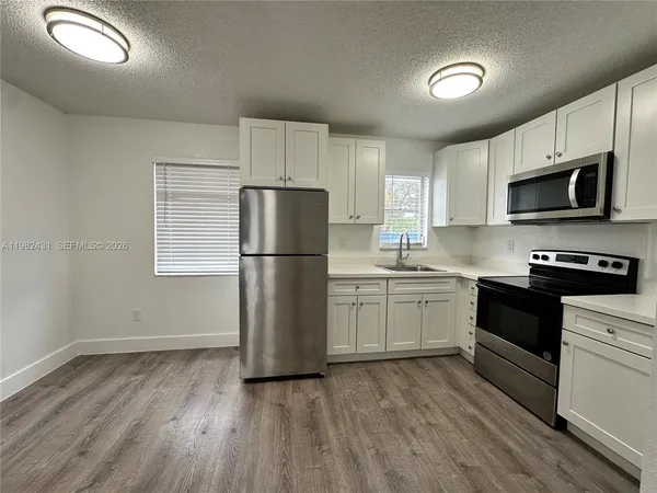 a kitchen with a refrigerator sink and microwave