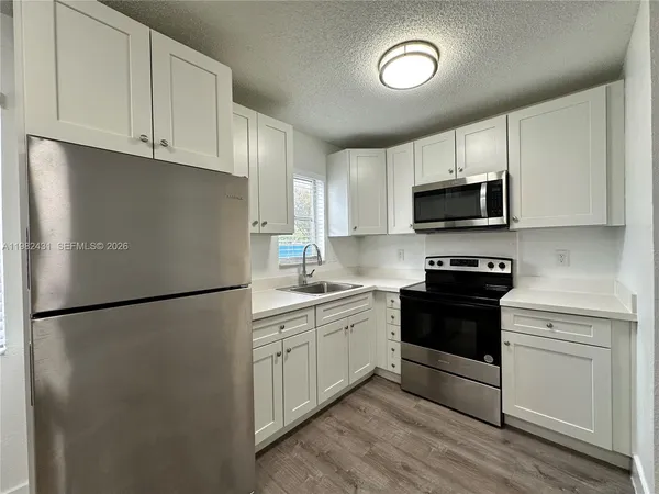 a kitchen with a refrigerator stove and microwave