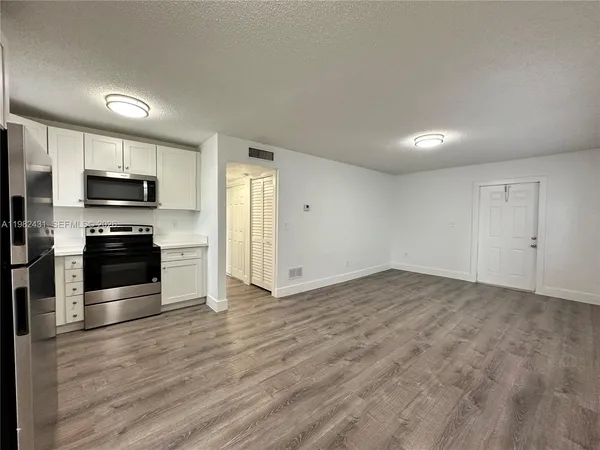 a kitchen with stainless steel appliances a refrigerator and a stove top oven