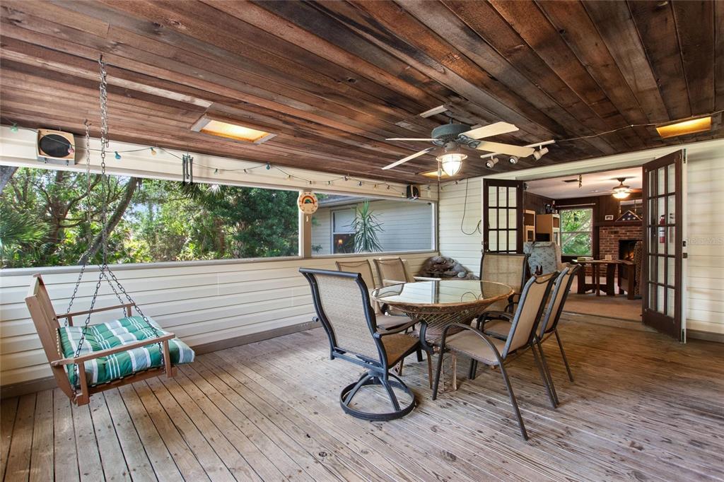 3641 Turtle Mound Road Melbourne, FL 32934 - Photo 17 of 77 a view of a patio with table and chairs and wooden floor