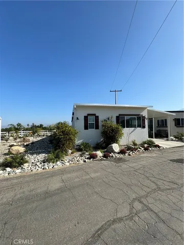 a view of a house with backyard sitting area and porch