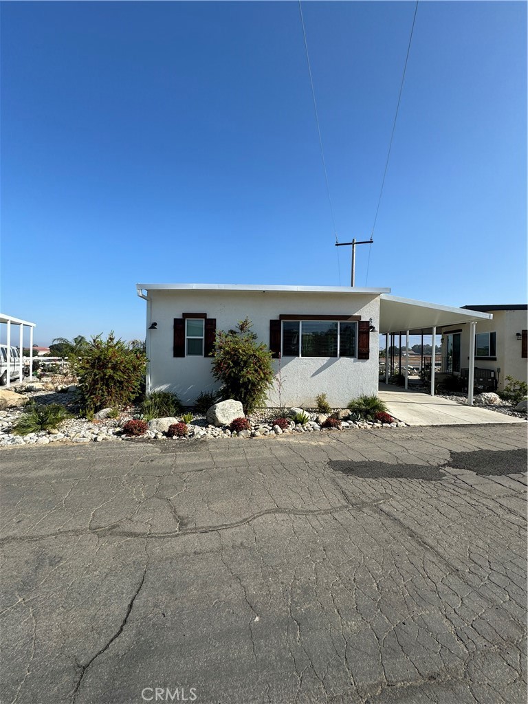 1134 Villa Calimesa Lane, Unit 61 Calimesa, CA 92320 - Photo 2 of 3 a view of a house with a patio