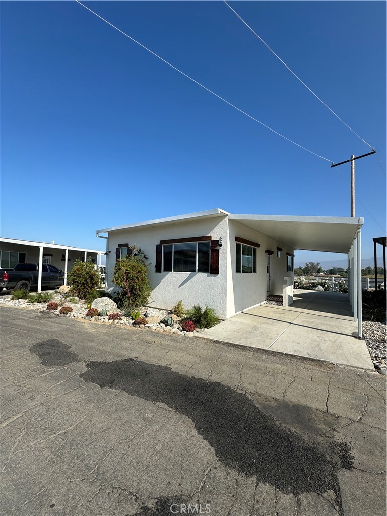 1134 Villa Calimesa Lane, Unit 61 Calimesa, CA 92320 - Photo 3 of 3 a front view of a house with a yard and garage