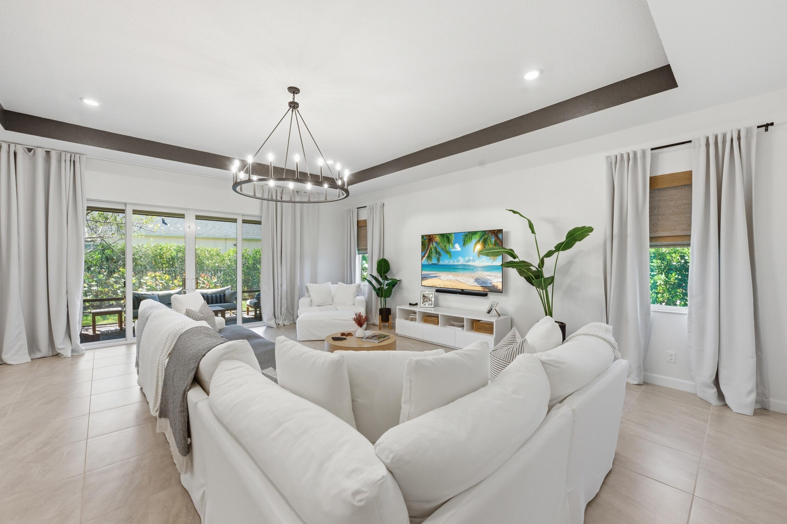 19230 Rolling Acres Road Loxahatchee, FL 33470 - Photo 4 of 58 a living room with furniture and a chandelier
