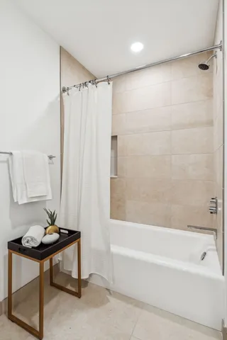 a bathroom with a bathtub a sink and a shower