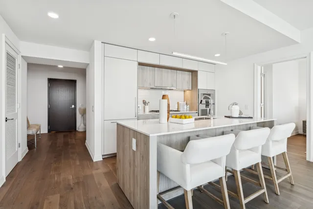 a kitchen with a sink and chairs