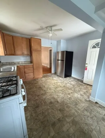a kitchen with refrigerator and window