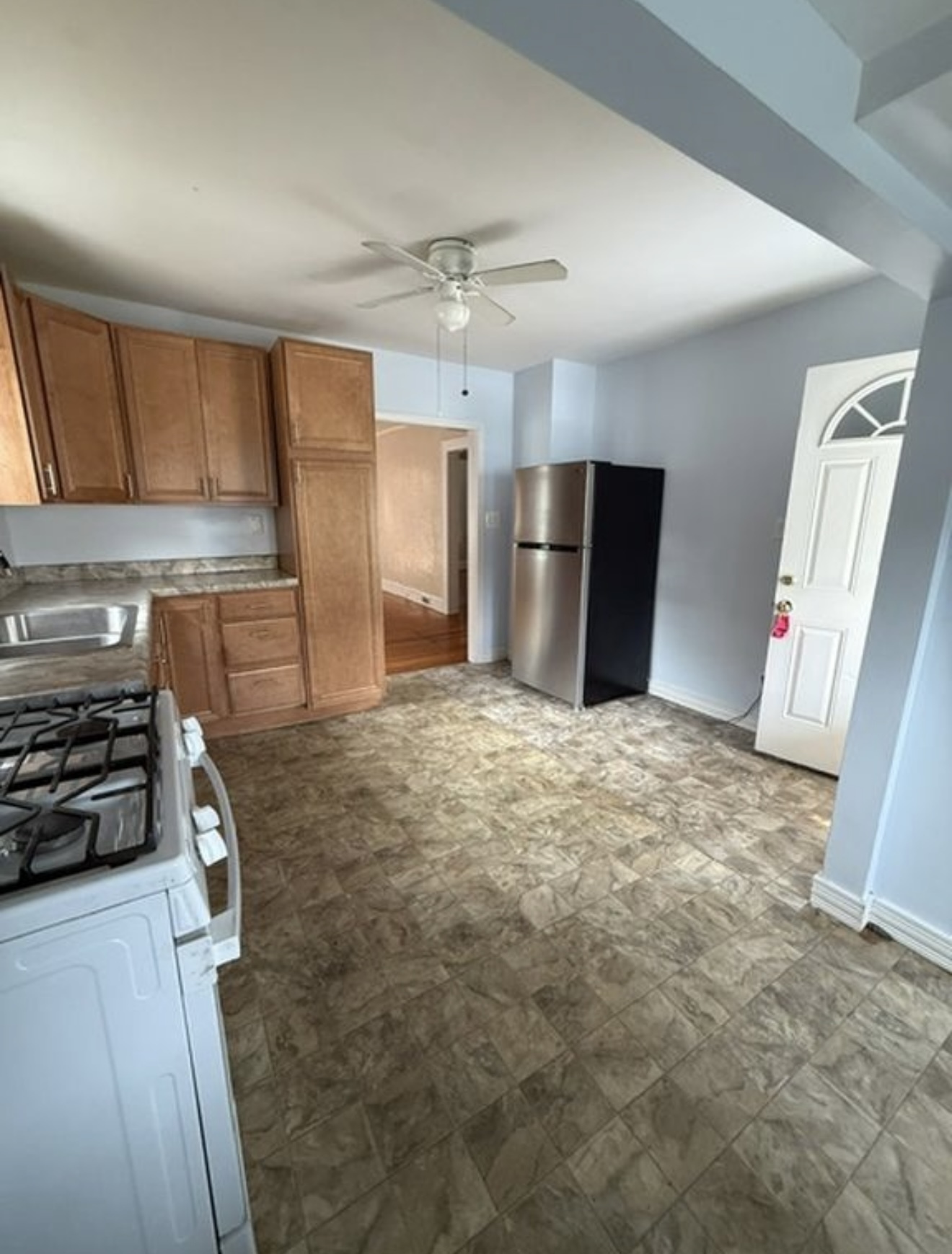 a kitchen with refrigerator and window