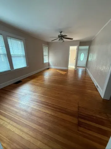 wooden floor in an empty room with a window