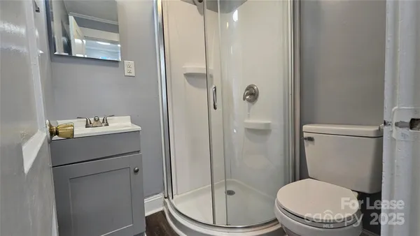 a bathroom with a toilet and a shower