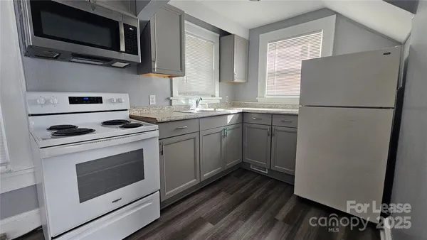 a kitchen with a sink stove and microwave