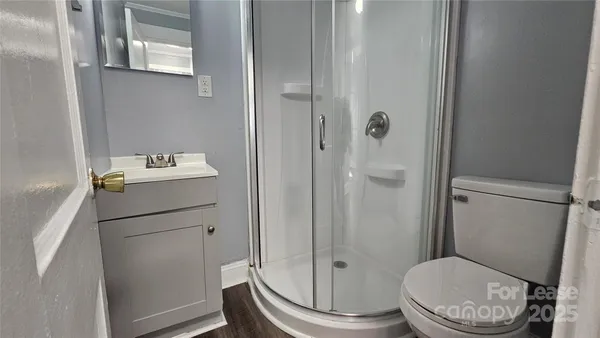 a white toilet sitting next to a bathroom sink