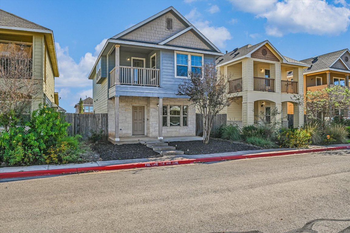 4609 Esper Lane, Unit 323 Austin, TX 78725 - Photo 1 of 20 a front view of a house with a yard and a garage