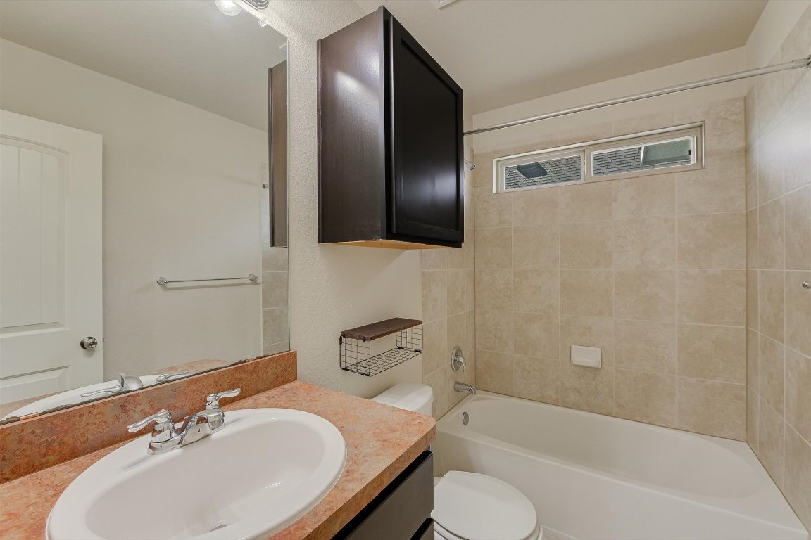 4609 Esper Lane, Unit 323 Austin, TX 78725 - Photo 15 of 20 a bathroom with a sink toilet and shower