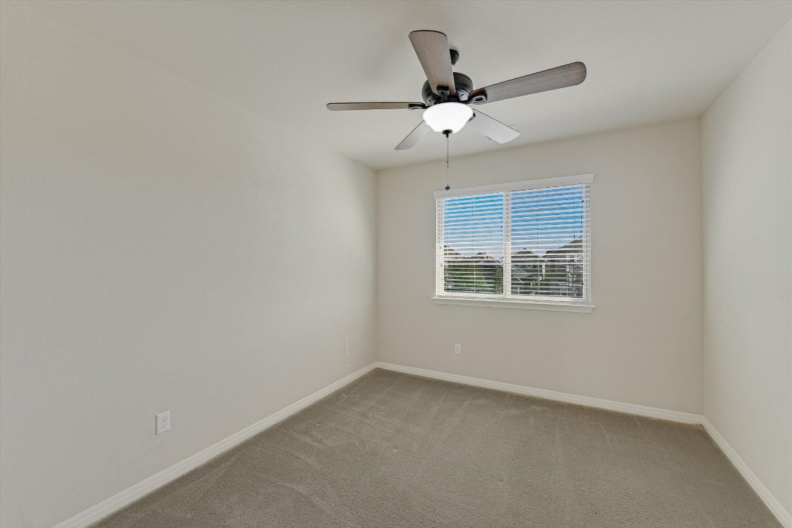 4609 Esper Lane, Unit 323 Austin, TX 78725 - Photo 16 of 20 an empty room with a window and a fan