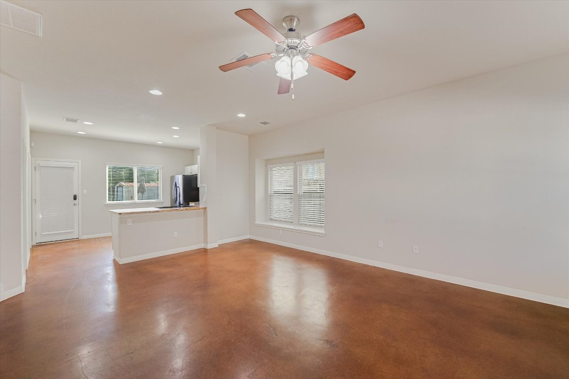 4609 Esper Lane, Unit 323 Austin, TX 78725 - Photo 5 of 20 a view of an empty room with window and wooden floor
