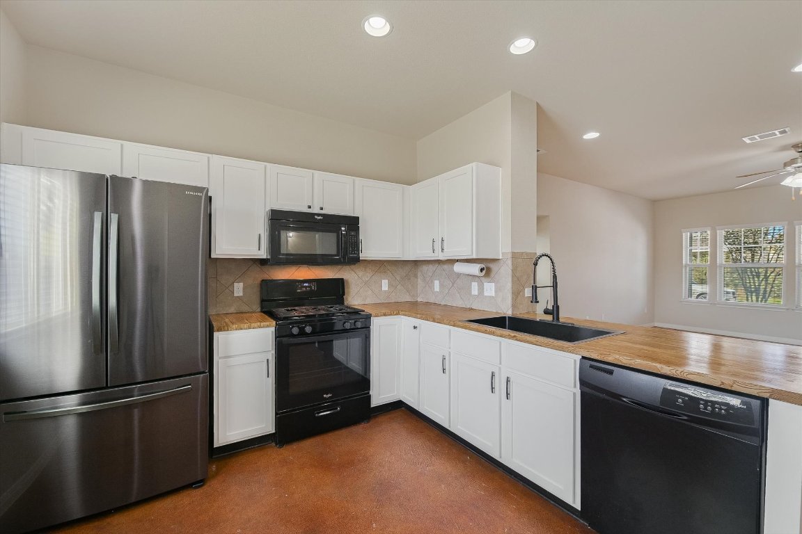 4609 Esper Lane, Unit 323 Austin, TX 78725 - Photo 7 of 20 a kitchen with stainless steel appliances granite countertop a refrigerator sink and stove