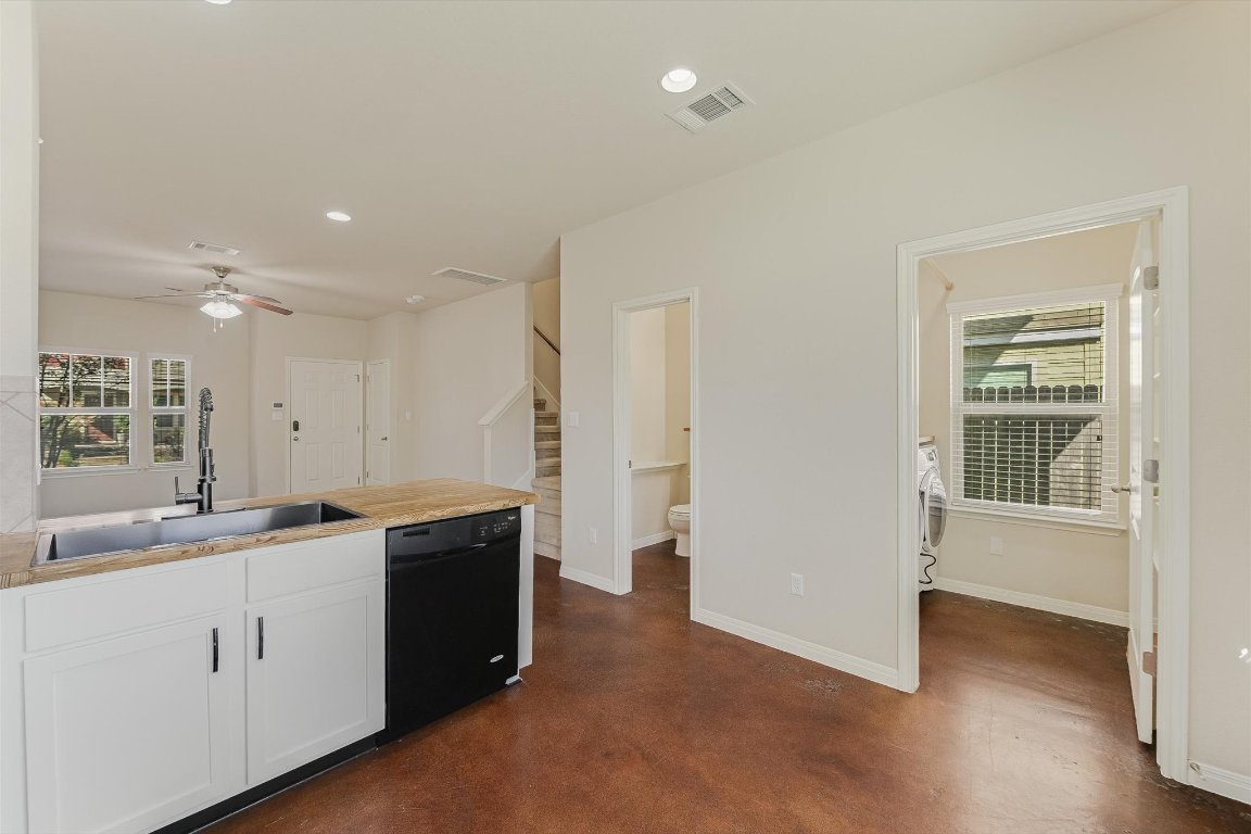 4609 Esper Lane, Unit 323 Austin, TX 78725 - Photo 8 of 20 a view of a kitchen with a sink and dishwasher with wooden floor