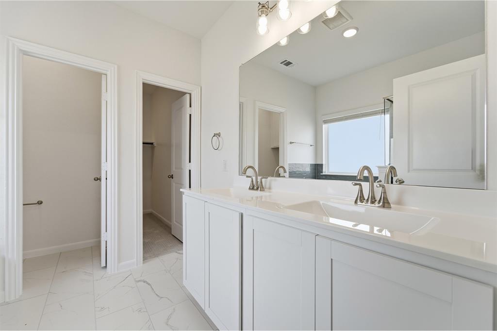 213 Charismatic Road Waxahachie, TX 75165 - Photo 16 of 21 a bathroom with a sink double vanity and a mirror