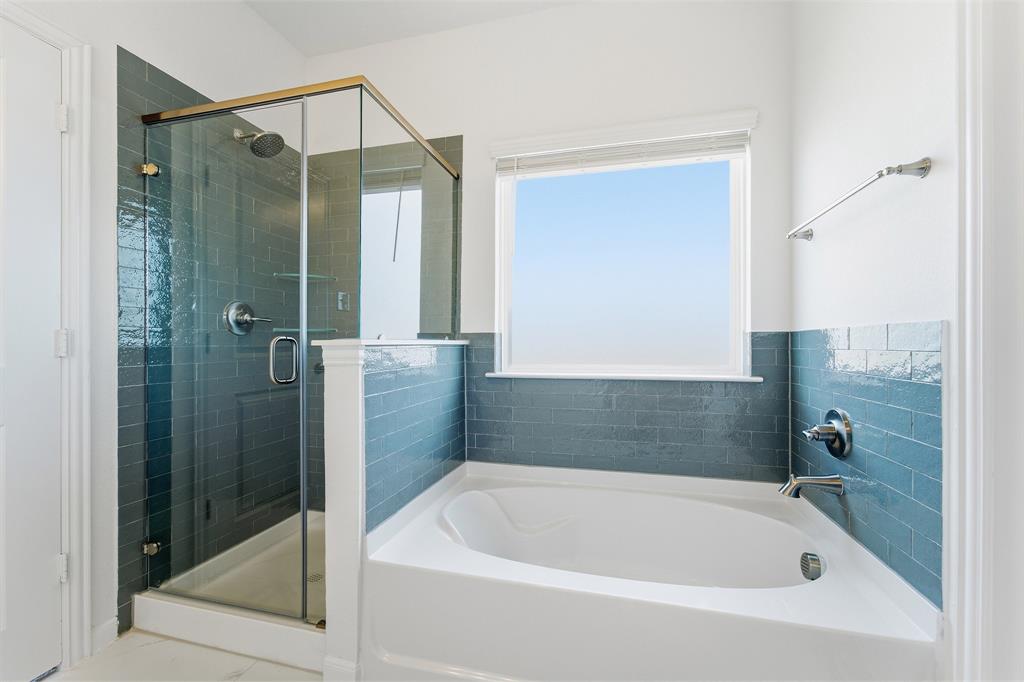 213 Charismatic Road Waxahachie, TX 75165 - Photo 17 of 21 a bathroom with a bathtub and shower