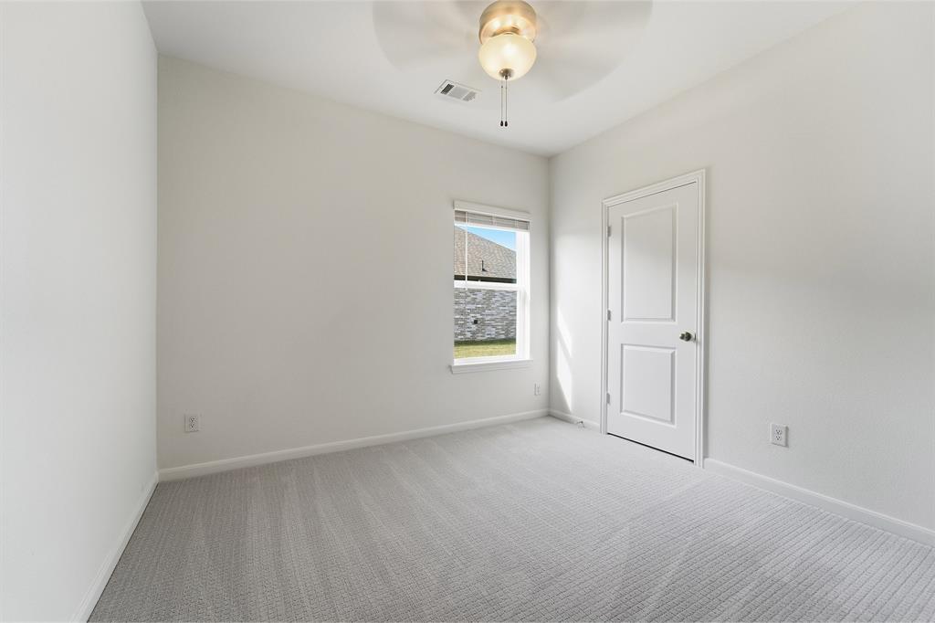 213 Charismatic Road Waxahachie, TX 75165 - Photo 18 of 21 an empty room with windows