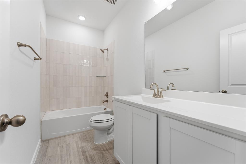 213 Charismatic Road Waxahachie, TX 75165 - Photo 20 of 21 a bathroom with a sink a toilet and shower