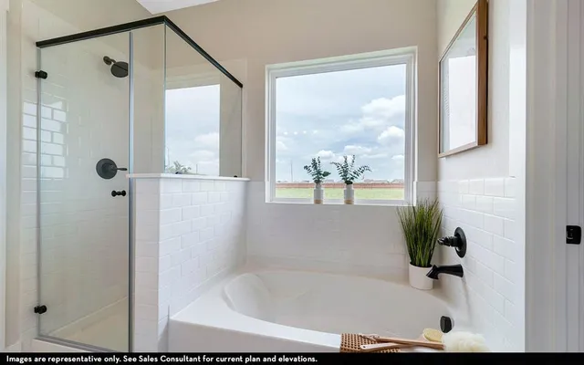 a bathroom with a tub and shower