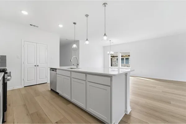 a spacious bathroom with a granite countertop sink a mirror and a shower