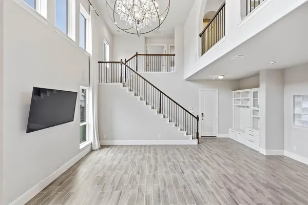 a view of empty room with wooden floor and ceiling fan