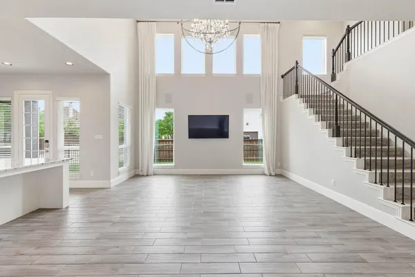 a view of a livingroom with wooden floor and a fireplace
