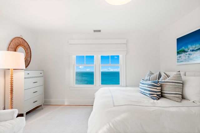 a bedroom with a bed and a lamp