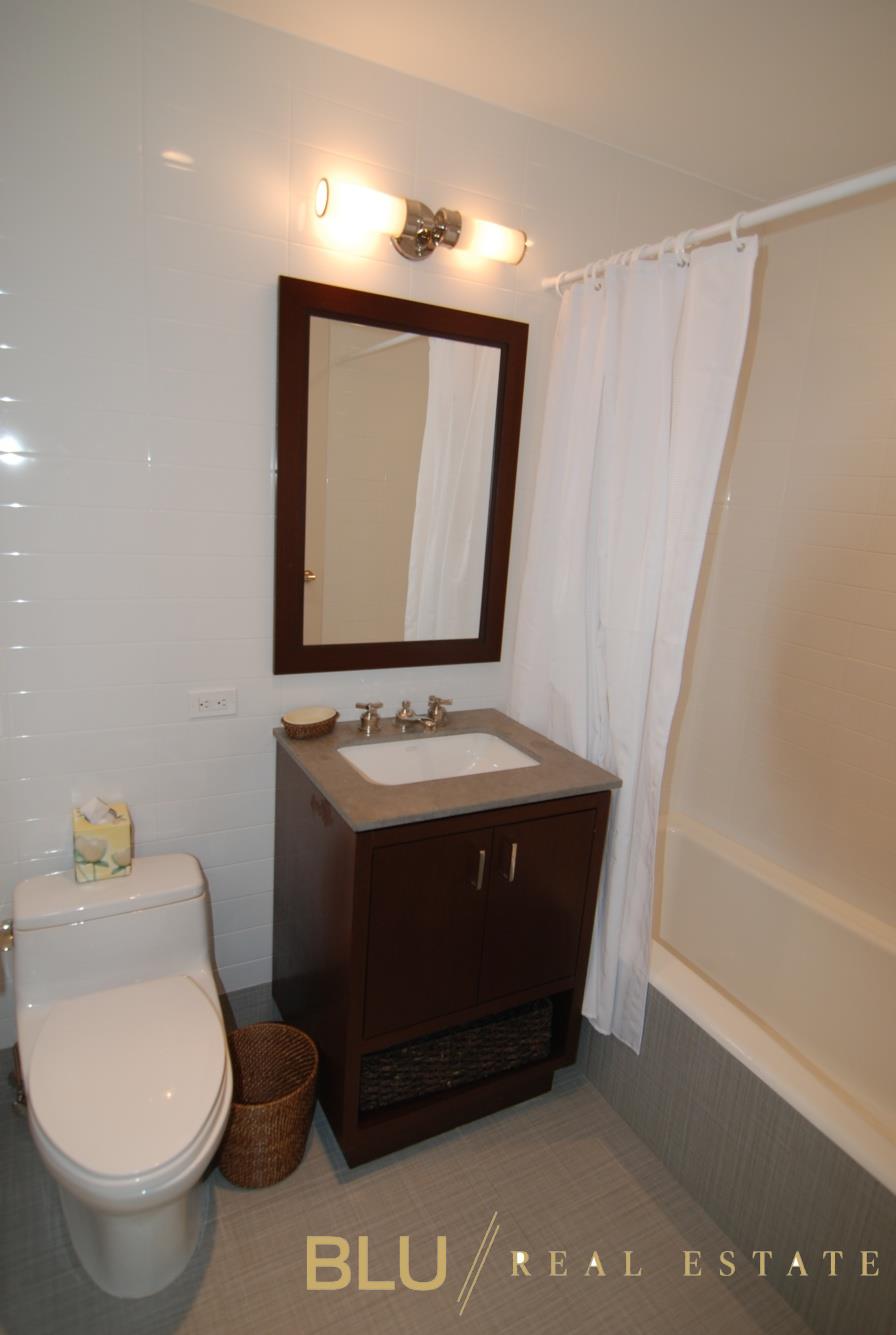 100 Riverside Boulevard, Unit 16E Manhattan, NY 10069 - Photo 8 of 11 a bathroom with a toilet sink and mirror