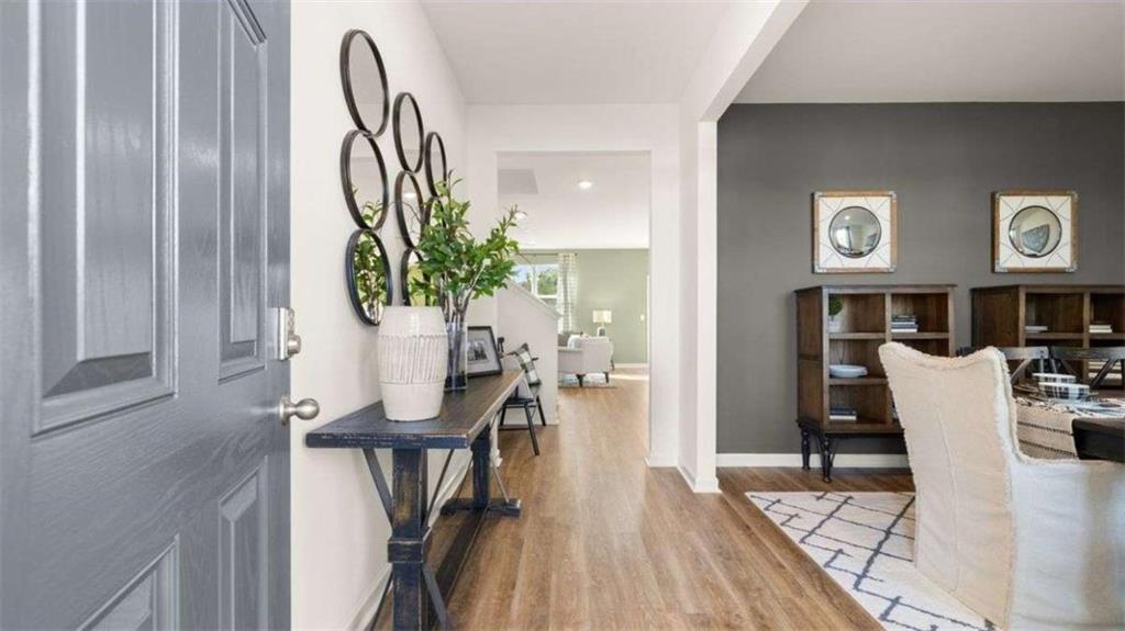 a view of a dining room with furniture and wooden floor