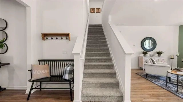 a view of entryway and hall with wooden floor