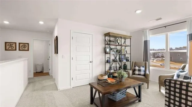 a living room with furniture and a floor to ceiling window