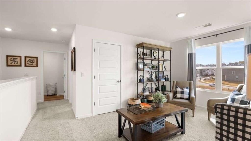 96 White Spruce Way Newnan, GA 30265 - Photo 17 of 43 a living room with furniture and a floor to ceiling window