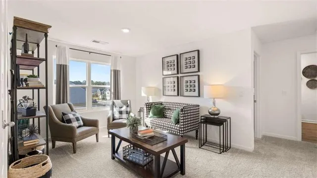 a living room with furniture a bookshelf and a window