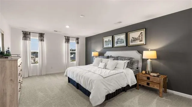 a bedroom with a bed and a night stand