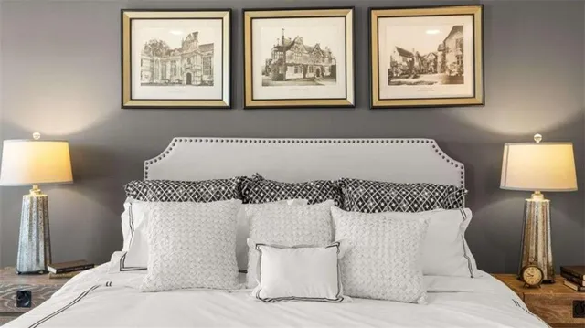 a bed sitting in a bedroom next to a lamp