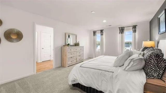 a bedroom with a bed and cabinets