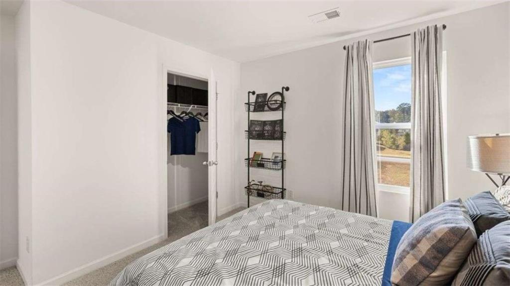 96 White Spruce Way Newnan, GA 30265 - Photo 32 of 43 a bedroom with a bed and a window