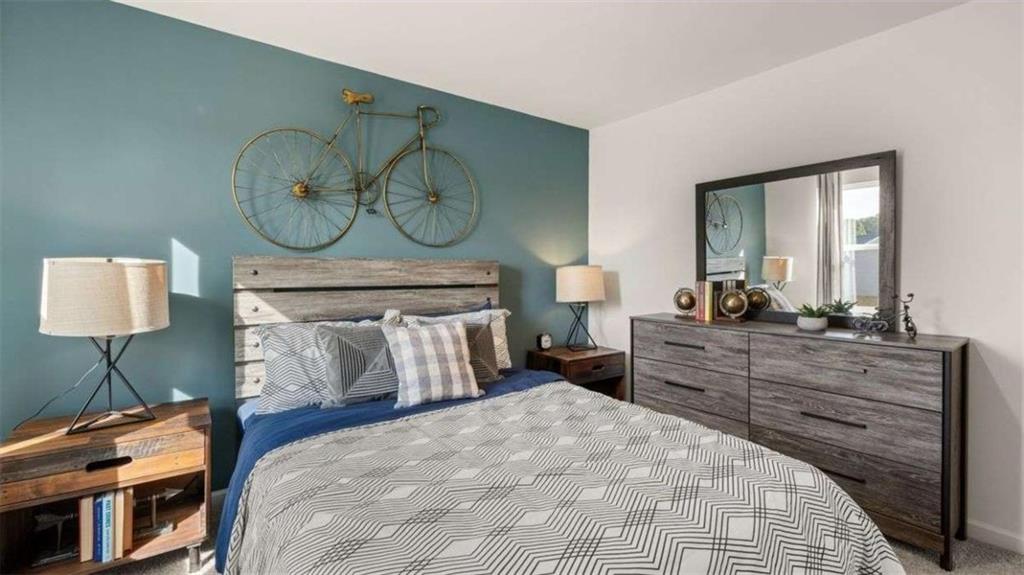 96 White Spruce Way Newnan, GA 30265 - Photo 33 of 43 a bed room with a bed and a lamp