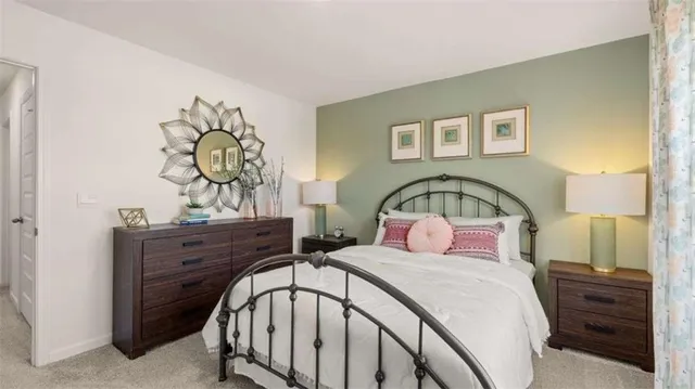 a bedroom with a bed and a dresser