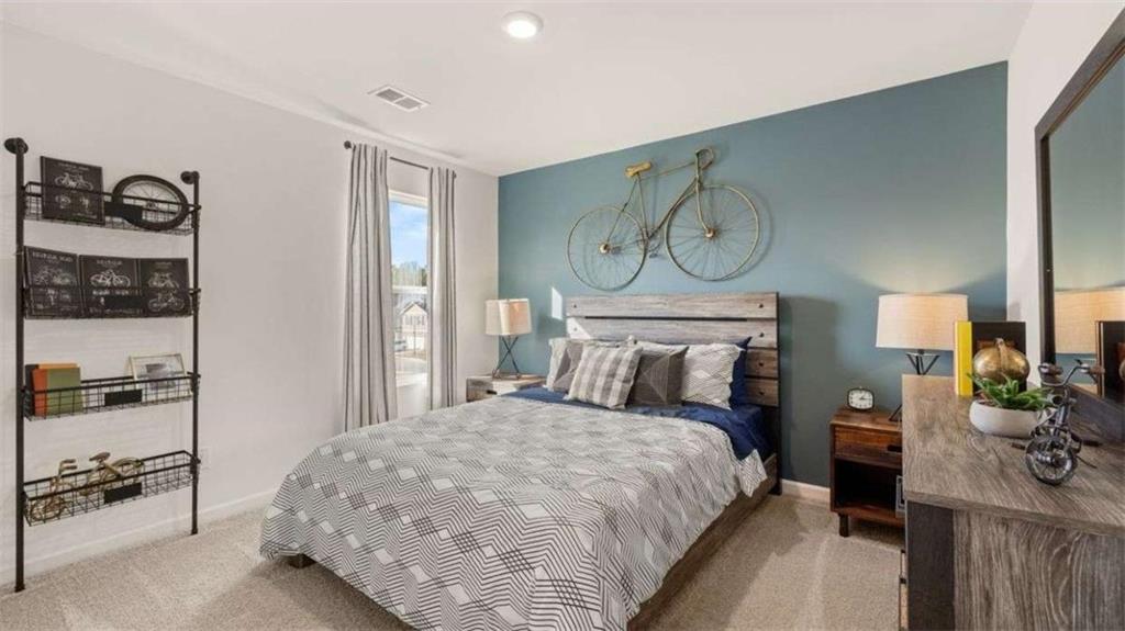 96 White Spruce Way Newnan, GA 30265 - Photo 38 of 43 a bedroom with a bed and a table in it