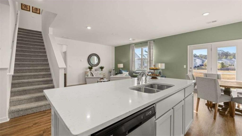 96 White Spruce Way Newnan, GA 30265 - Photo 4 of 43 a kitchen with a sink and a refrigerator